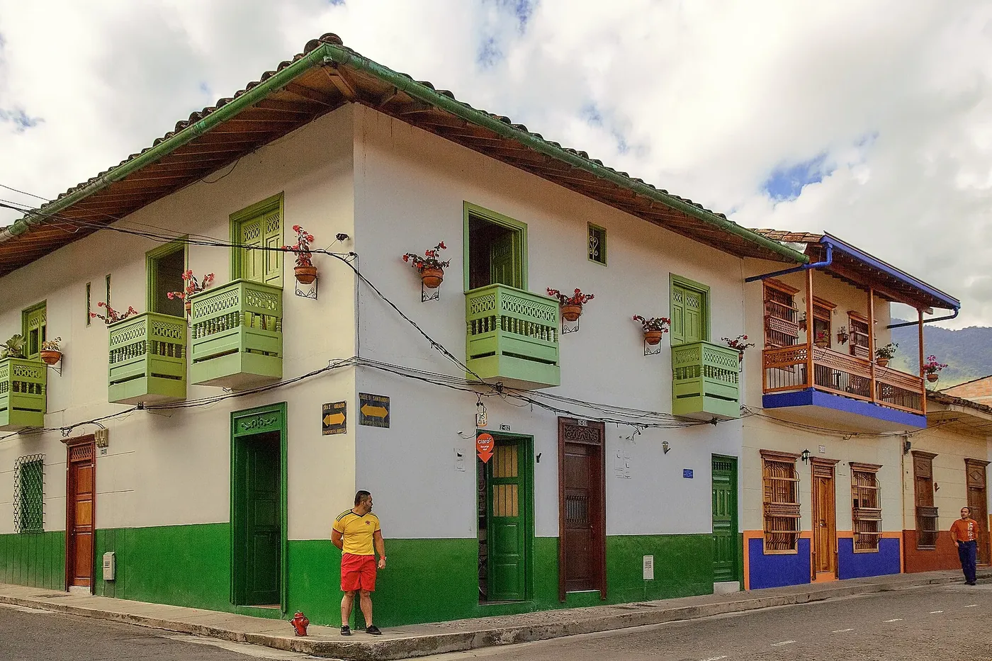 Casa esquinera blanca con balcones verdes en Jardín